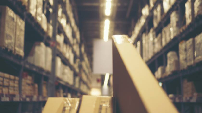 Blurred image of shelf in modern distribution warehouse or storehouse