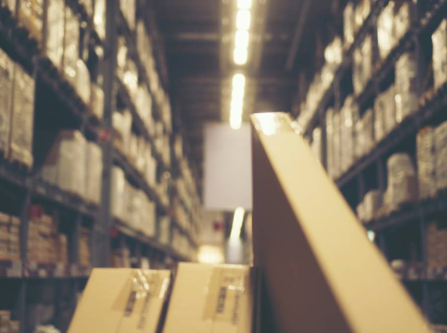 Blurred image of shelf in modern distribution warehouse or storehouse