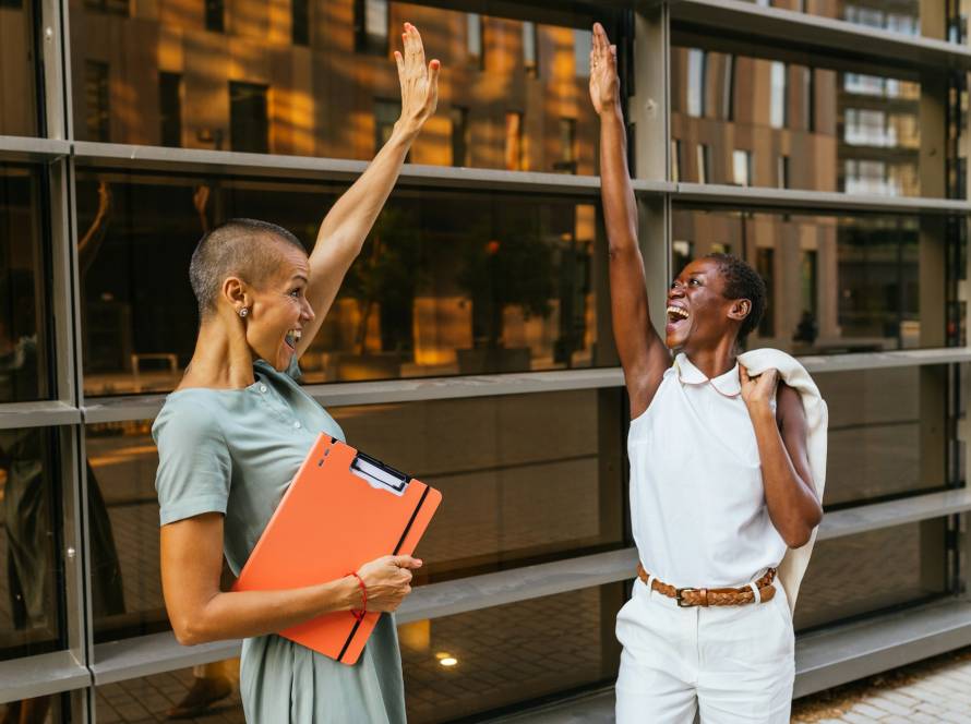 Joyful businesswomen celebrating success outdoors